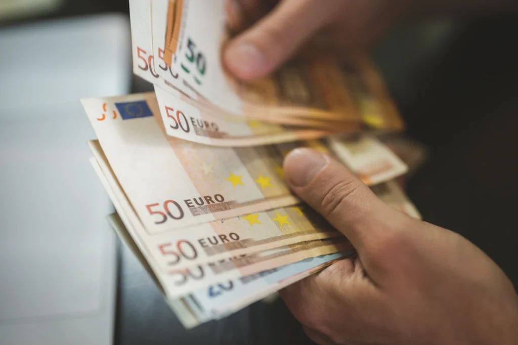 Une personne qui compte des billets de 50 euros